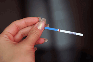 Close-up of a woman holding a test strip