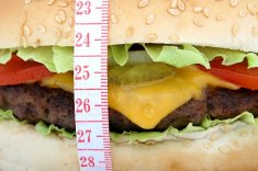 Close-up of a hamburger with a measuring tape around it