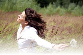 A woman happily running through a meadow
